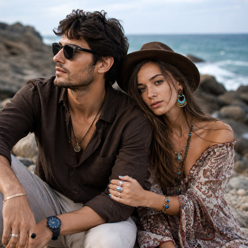 Couple sitting on a rocky beach with ocean view